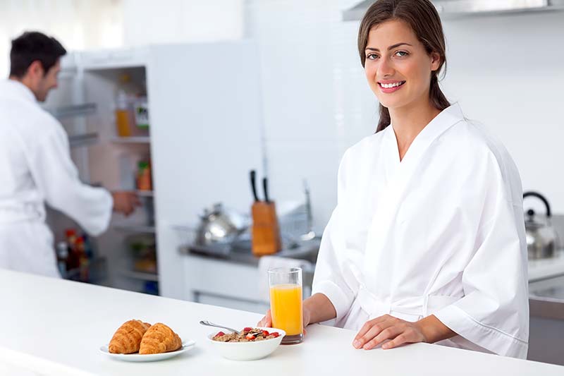 A Woman Having Breakfast in Bathrobe